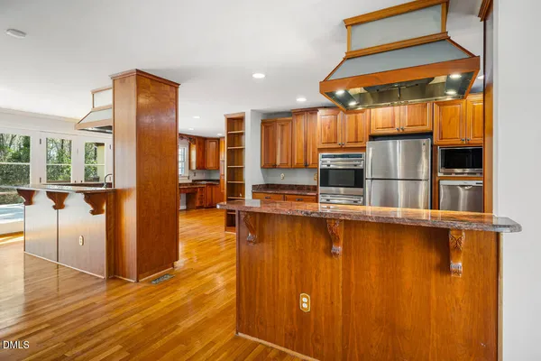a bathroom with a granite countertop sink a mirror and a shower
