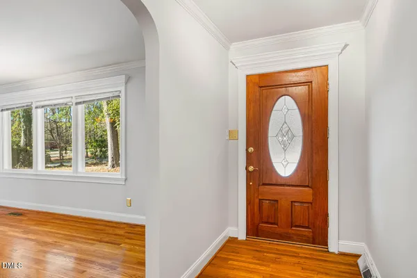 a kitchen with stainless steel appliances granite countertop a refrigerator a sink dishwasher and wooden cabinets with wooden floor