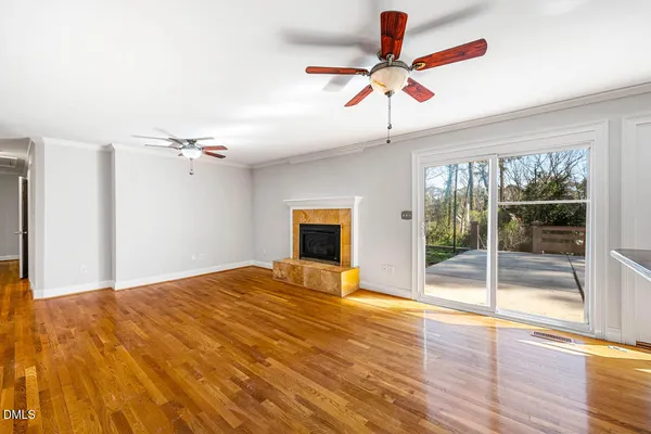 a large kitchen with stainless steel appliances wooden floors and large window