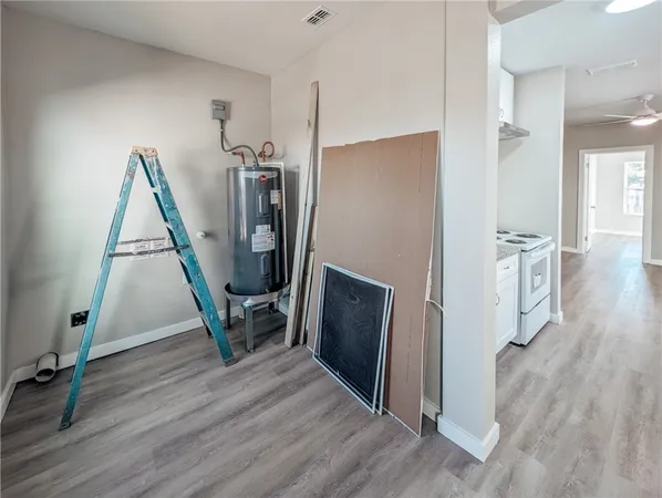 a view of a hallway with wooden floor windows and a living room