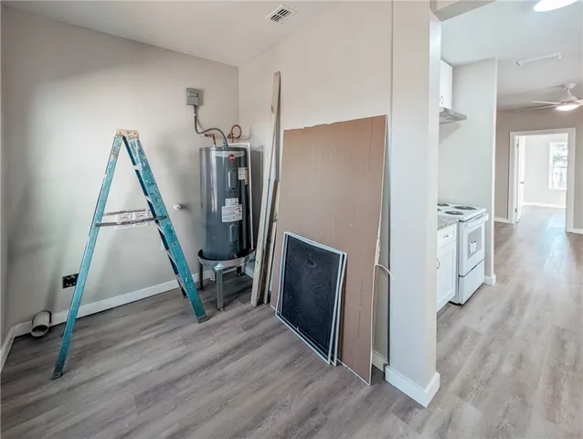 a view of a hallway with wooden floor windows and a living room