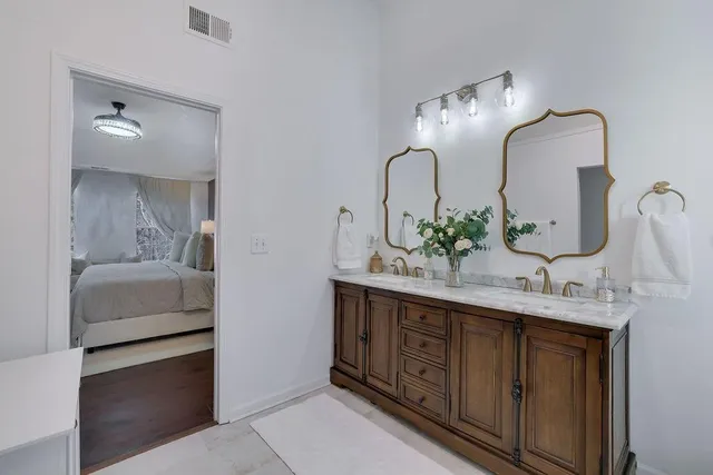 a bathroom with a double vanity sink and a mirror