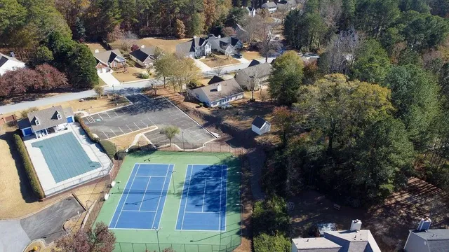 an aerial view of a house with a yard basket ball court and outdoor seating