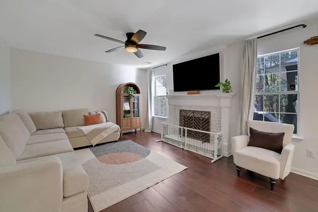 a living room with furniture fireplace and flat screen tv