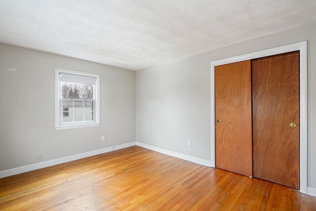 10-12 Norcross Circle Arlington, MA 02474 - Photo 14 of 31 a view of empty room with wooden floor and fan