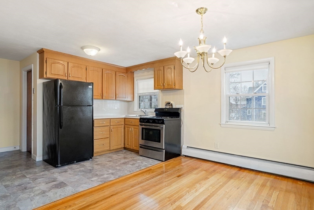 10-12 Norcross Circle Arlington, MA 02474 - Photo 6 of 31 a kitchen with stainless steel appliances granite countertop a refrigerator a oven a sink dishwasher and a refrigerator with wooden floor