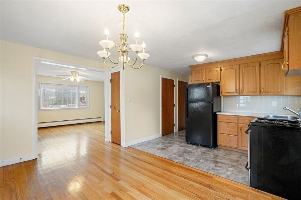10-12 Norcross Circle Arlington, MA 02474 - Photo 8 of 31 a kitchen with stainless steel appliances granite countertop a refrigerator a stove a sink dishwasher and a refrigerator with wooden floor