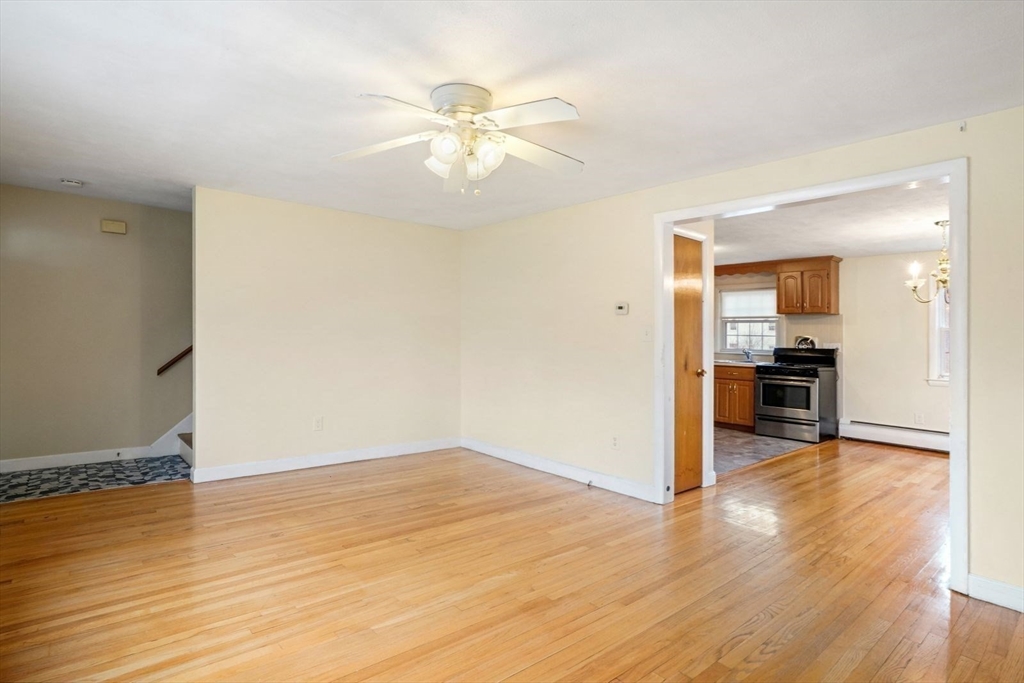 10-12 Norcross Circle Arlington, MA 02474 - Photo 9 of 31 a view of a kitchen with wooden floor and a ceiling fan