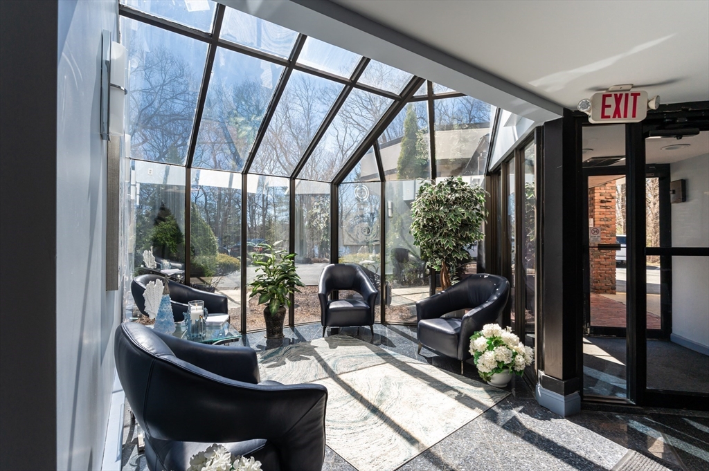 9 Broadway, Unit 223 Saugus, MA 01906 - Photo 13 of 18 a living room with furniture and a floor to ceiling window