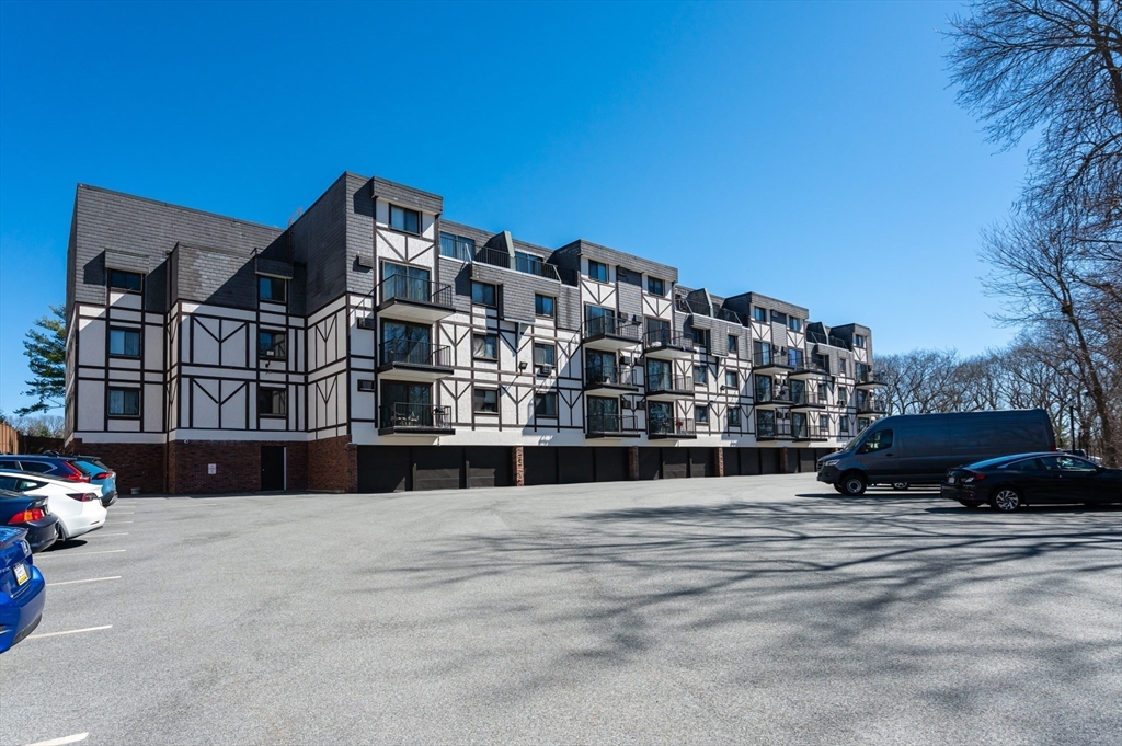 9 Broadway, Unit 223 Saugus, MA 01906 - Photo 18 of 18 a view of buildings with yard and car parked