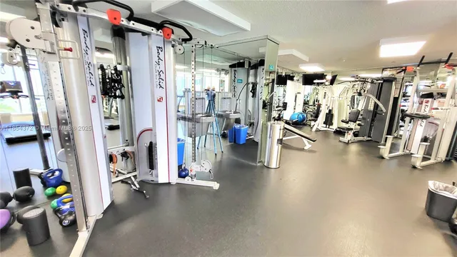 a view of a living room with furniture and floor to ceiling windows