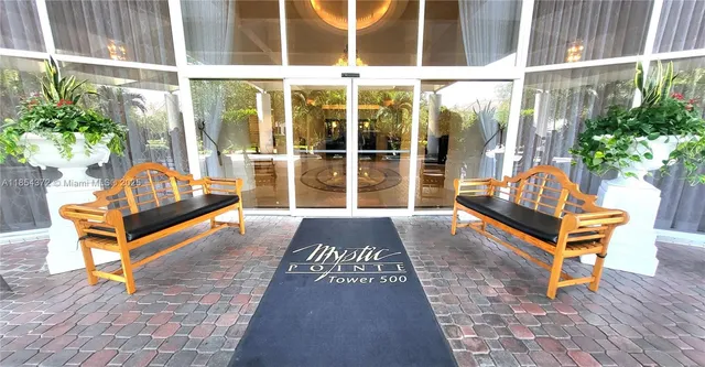 a building outdoor space with patio furniture and potted plants