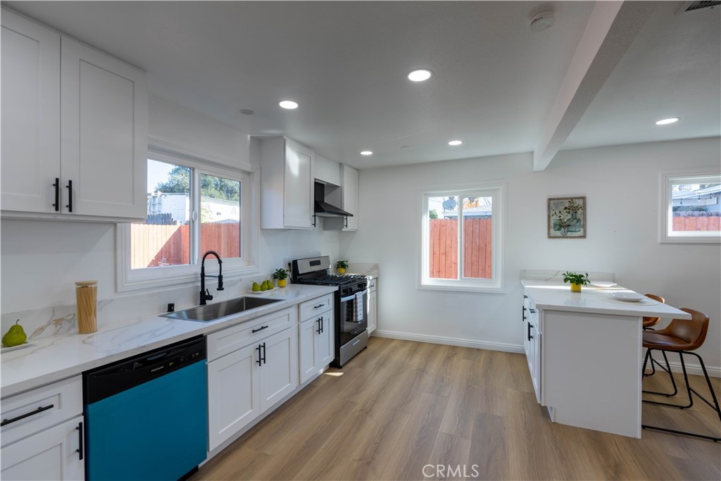 4065 Madrona Road Riverside, CA 92504 - Photo 11 of 35 a kitchen with a sink wooden floor and view living room