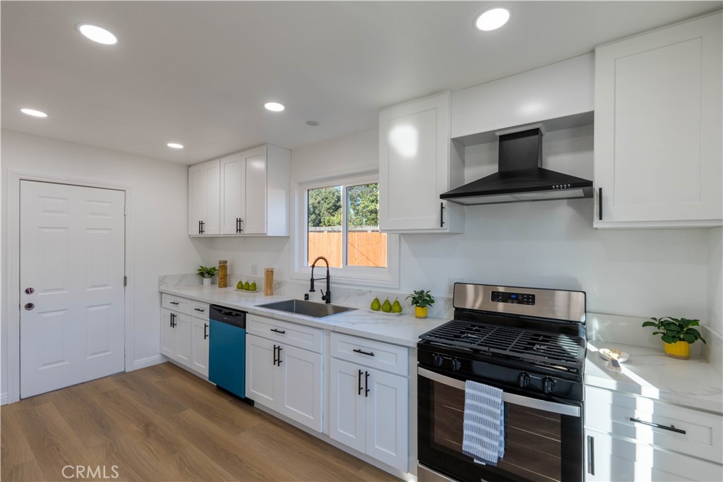 4065 Madrona Road Riverside, CA 92504 - Photo 13 of 35 a kitchen with stainless steel appliances granite countertop a sink stove top oven and cabinets