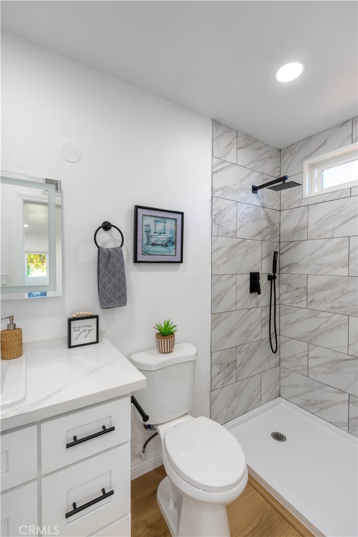 4065 Madrona Road Riverside, CA 92504 - Photo 21 of 35 a bathroom with a sink toilet and shower