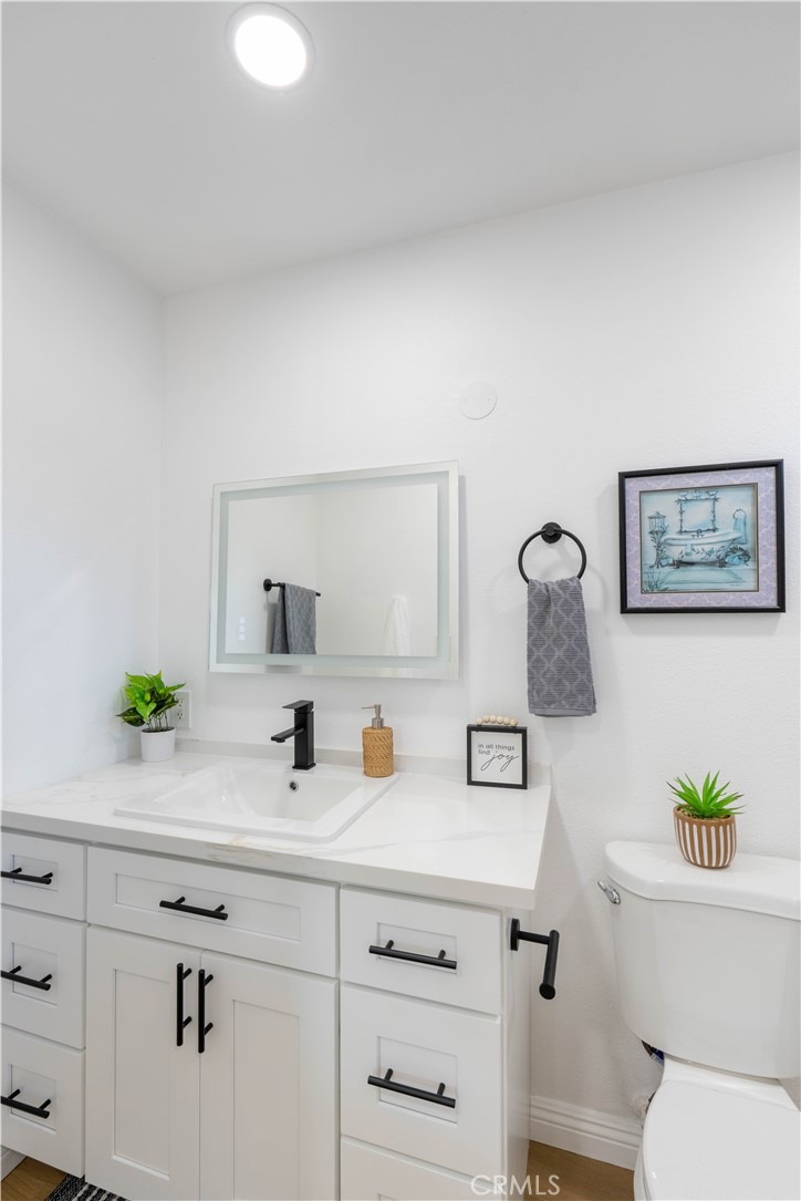 4065 Madrona Road Riverside, CA 92504 - Photo 22 of 35 a bathroom with a sink a toilet and a mirror