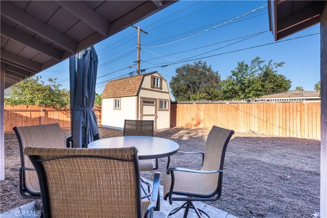 a view of balcony with a table and chairs