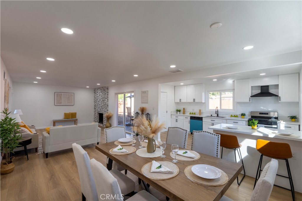 4065 Madrona Road Riverside, CA 92504 - Photo 7 of 35 a view of a dining room and livingroom view with furniture wooden floor a rug and a chandelier