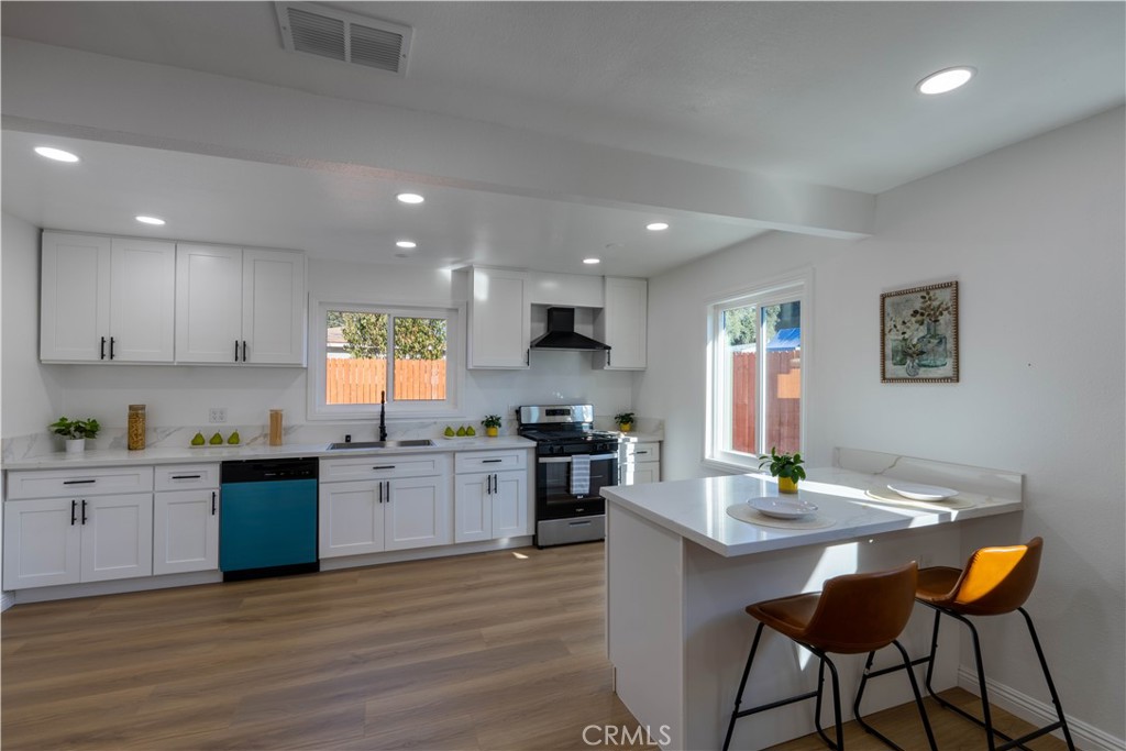 4065 Madrona Road Riverside, CA 92504 - Photo 10 of 35 a kitchen with stainless steel appliances kitchen island granite countertop a sink and cabinets