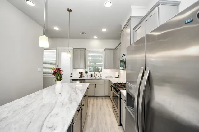 a kitchen with sink refrigerator and counter top space