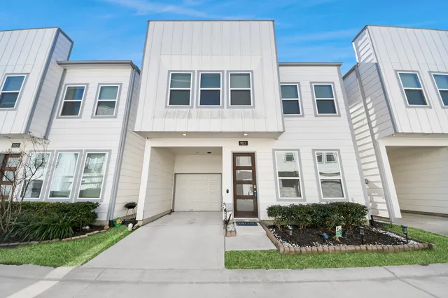 a front view of a building with a garden