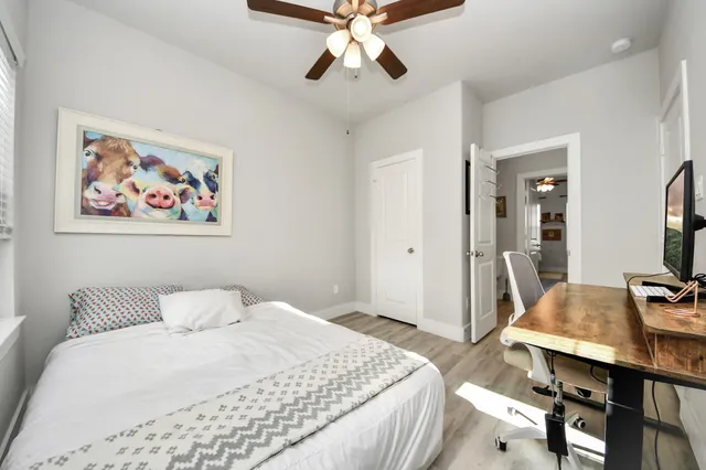 a bedroom with a bed and a chandelier