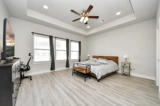 a bedroom with a bed and a large window