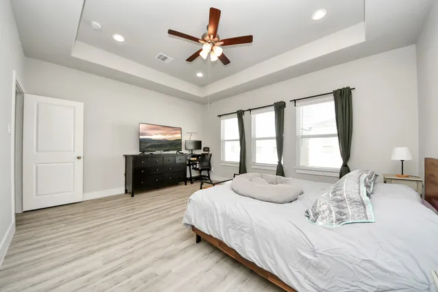 a bedroom with a bed and a large window