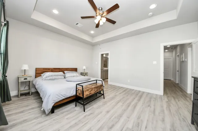 a bedroom with a bed and a ceiling fan
