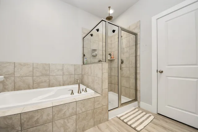 a bathroom with a bathtub and a shower