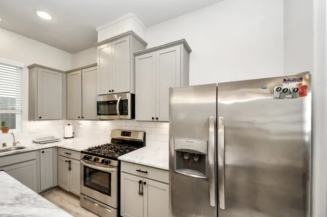 a kitchen with a refrigerator stove and microwave