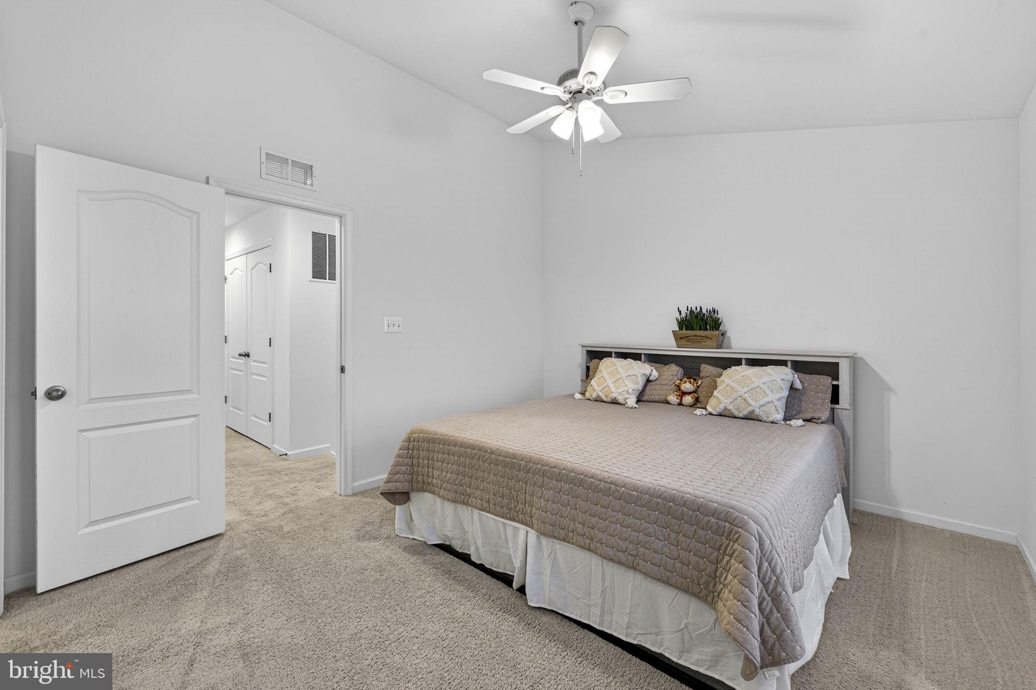 101 Union Ridge Drive Charles Town, WV 25414 - Photo 6 of 71 a bedroom with a bed and a chandelier