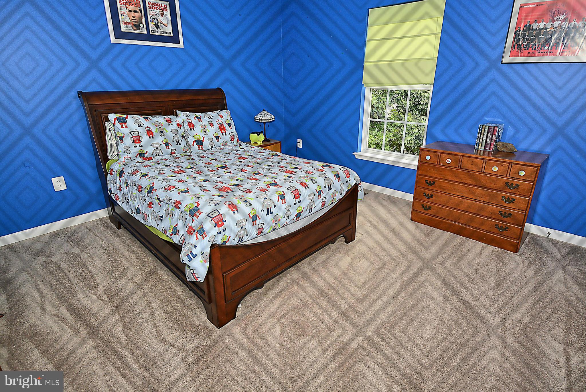 1702 Crommelins Court Point of Rocks, MD 21777 - Photo 9 of 12 a bed sitting in a bedroom next to a window with wooden floor