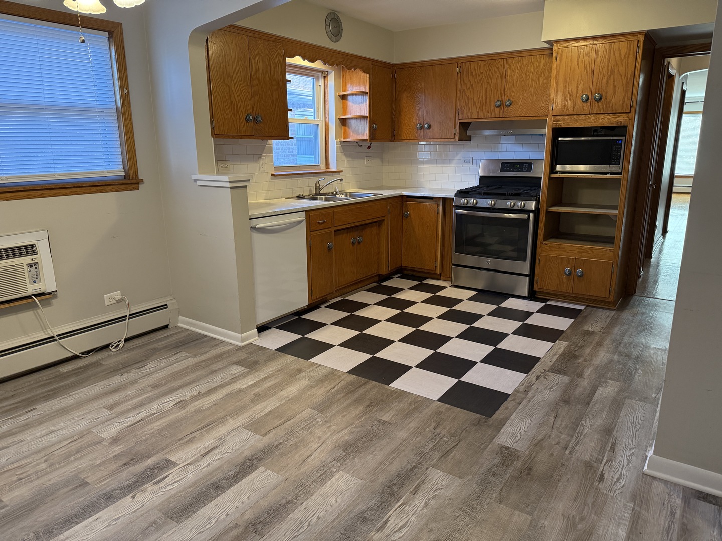 5736 West Gunnison Street, Unit 2 Chicago, IL 60630 - Photo 7 of 17 a kitchen with granite countertop stainless steel appliances a sink and counter space
