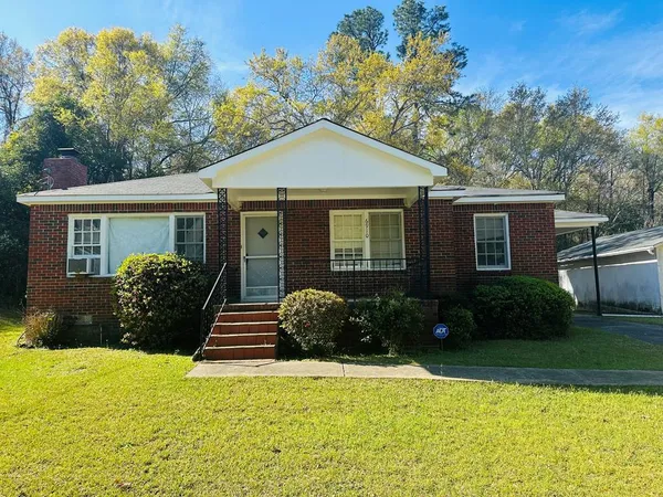 a front view of a house with garden