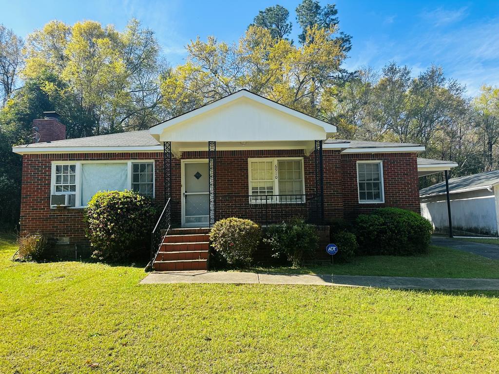 a front view of a house with garden