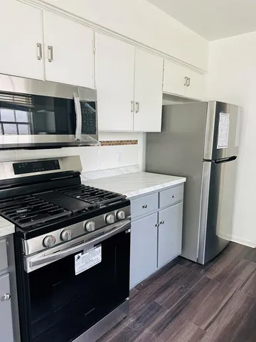 a kitchen with a stove and a refrigerator
