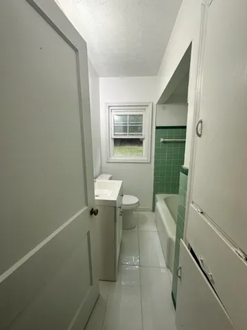 a bathroom with a sink toilet and tub