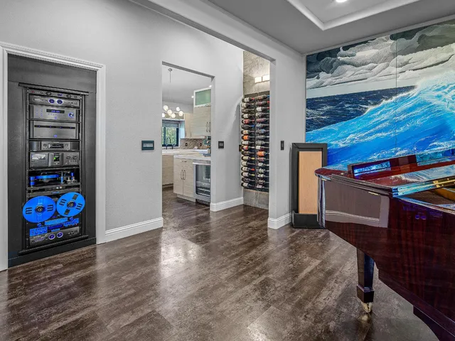 a kitchen with white cabinets stainless steel appliances and wooden floor