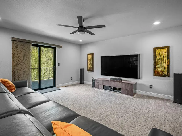 a living room with furniture and a ceiling fan