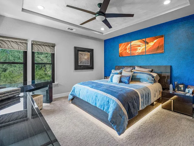 a bedroom with a bed and a flat screen television