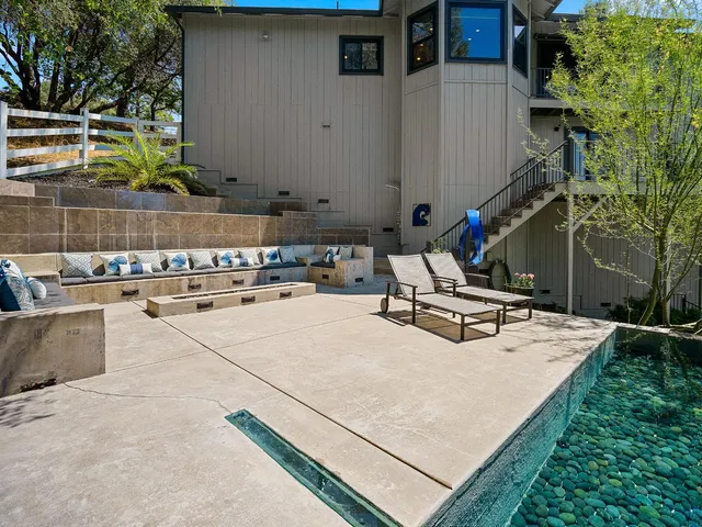 a view of a balcony with two chairs and a stove
