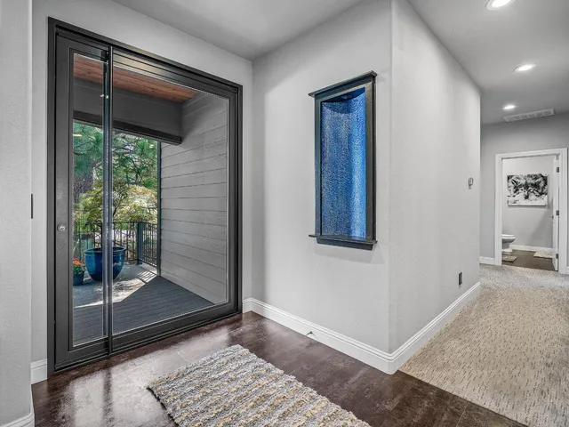 a view of a hallway with a glass door and a yard