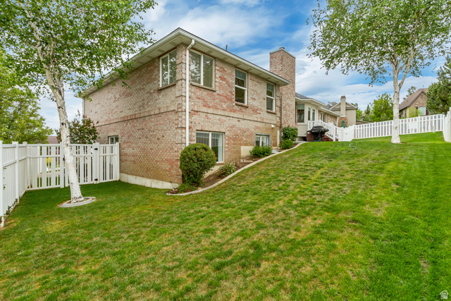 298 North Canyon Road Bountiful, UT 84010 - Photo 54 of 57 Expansive lawn with mature trees and a white picket fence enclosing the property