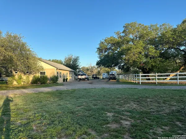 a view of backyard with wooden fence