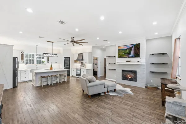 a living room with furniture a fireplace and a flat screen tv