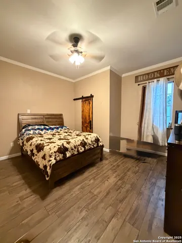 a bed sitting in a bedroom next to a window