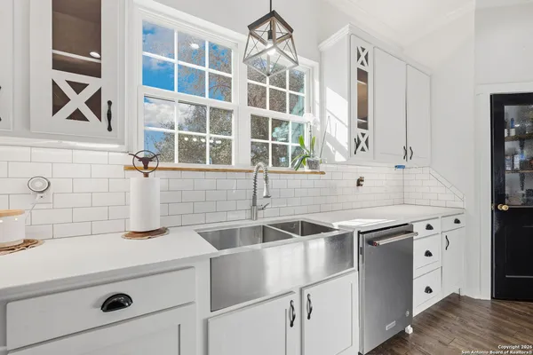 a kitchen with a sink and cabinets