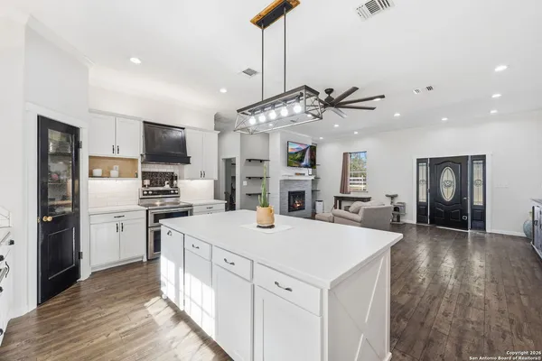 a kitchen with a stove a refrigerator and a sink