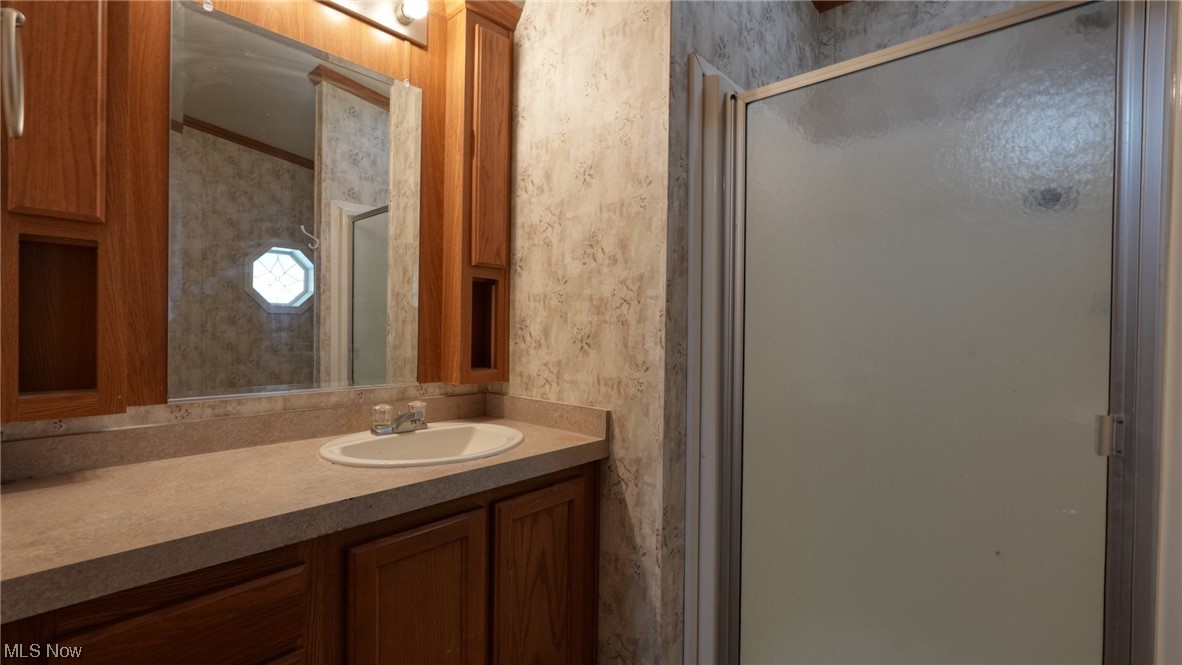 59062 Marietta Road Byesville, OH 43723 - Photo 13 of 33 Bathroom featuring oversized vanity, walk in shower, and crown molding